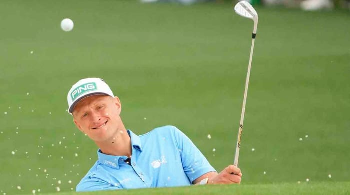 Adrian Meronk hits out of the bunker on the second hole during the first round of the 2023 Masters Tournament.